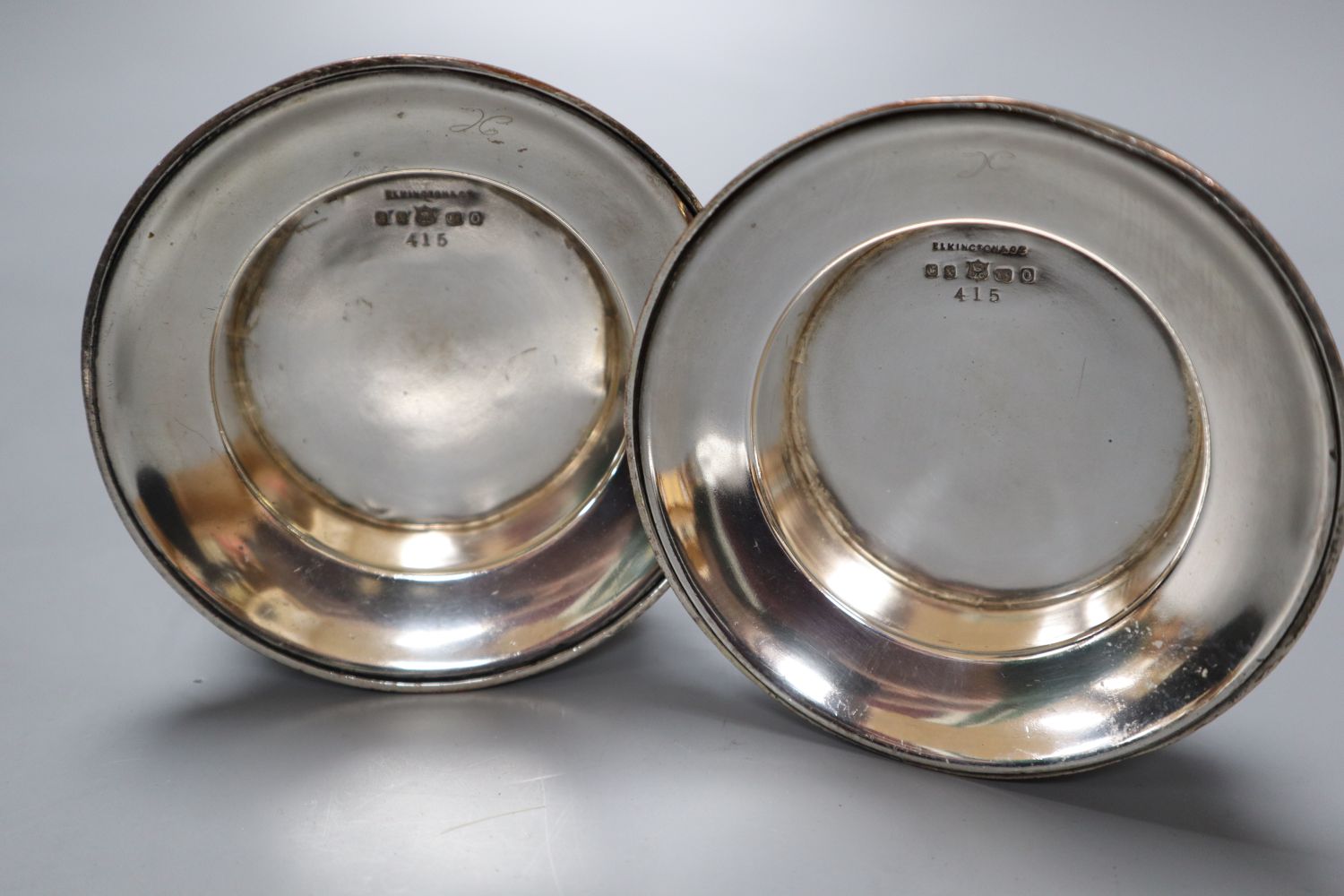 A pair of Elkington electrotype cast plated candlesticks, height 14cm